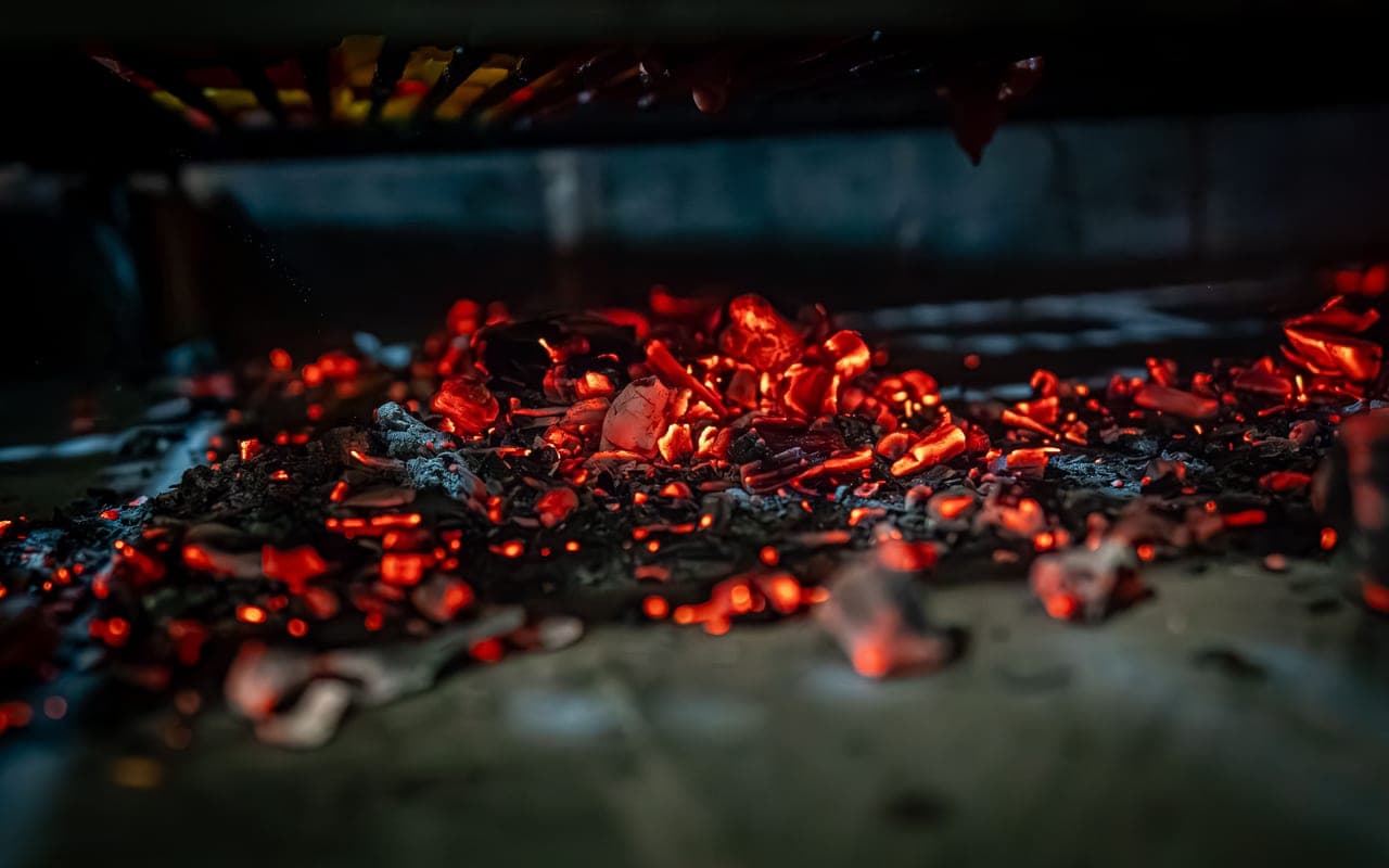 A charcoal fire burning in a smoker firebox
