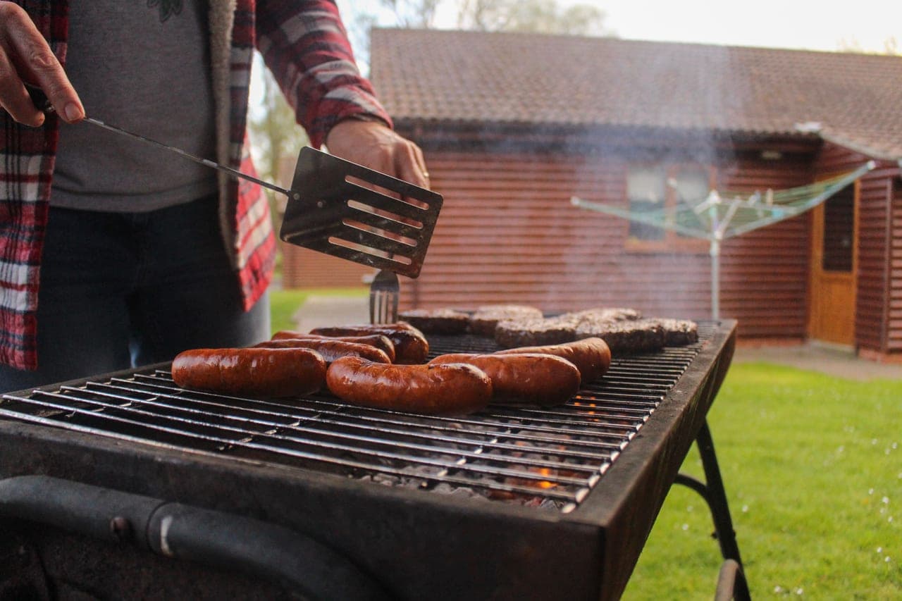 A pellet grill on a patio with the lid open